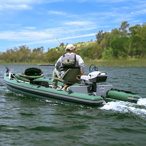 Man on a green sea eagle skiff inflatable boat with motor on a lake