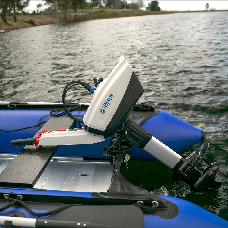 Blue kayak with a Bixpy motor on a body of water