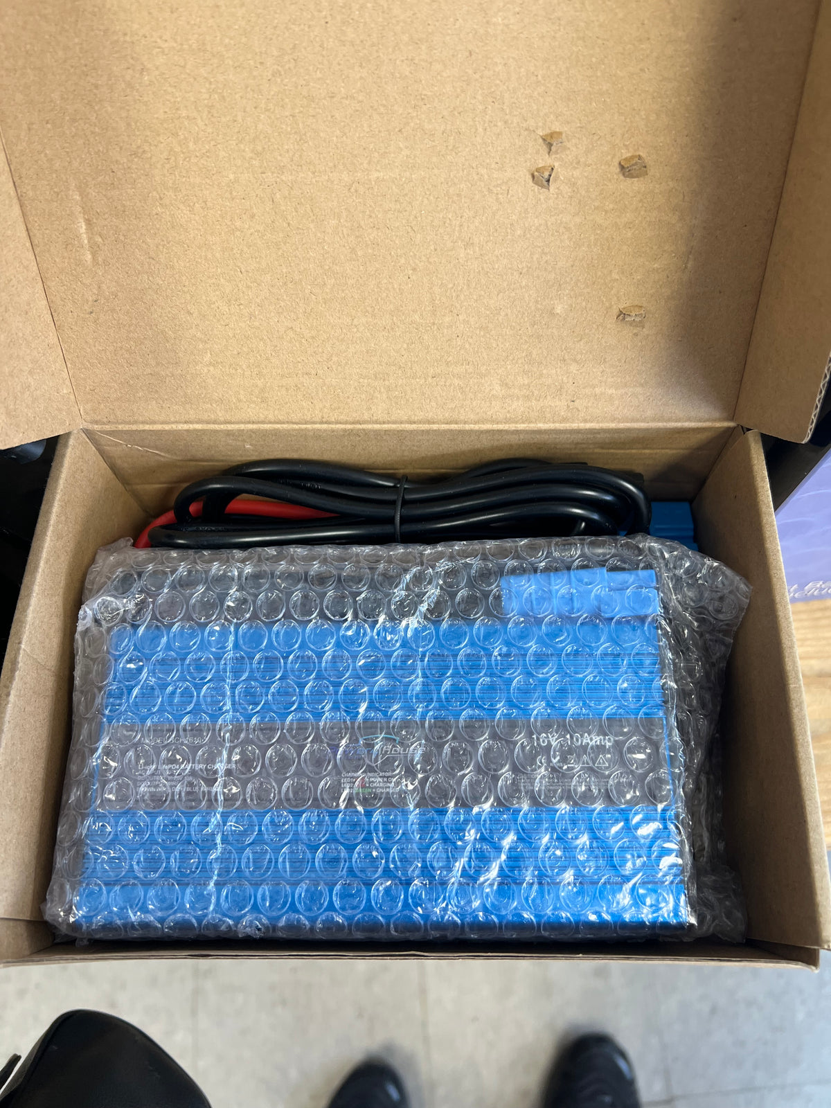 Product wrapped in bubble wrap inside an open cardboard box.