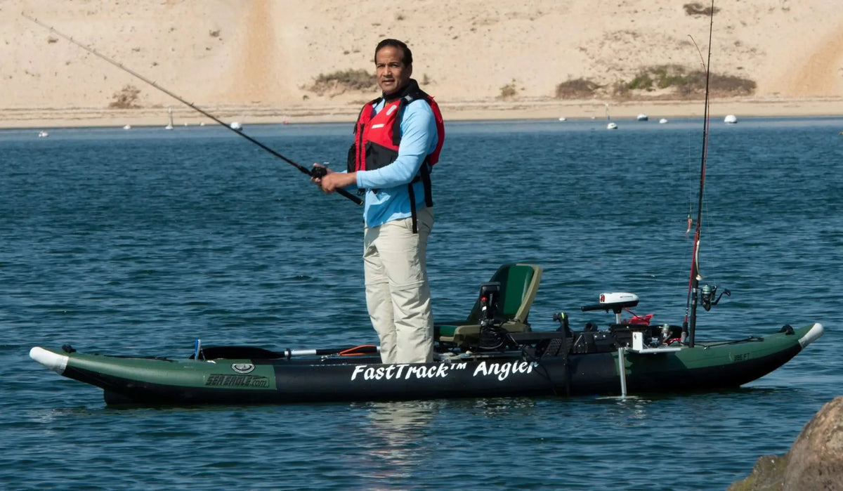 Man in red life vest fishing from a green Sea Eagle 385fta FastTrack™ Angler inflatable kayak.
