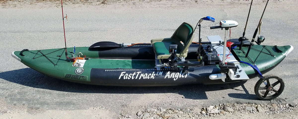 Green and black Sea Eagle 385fta FastTrack Angler inflatable kayak with fishing gear, motor, and cart.