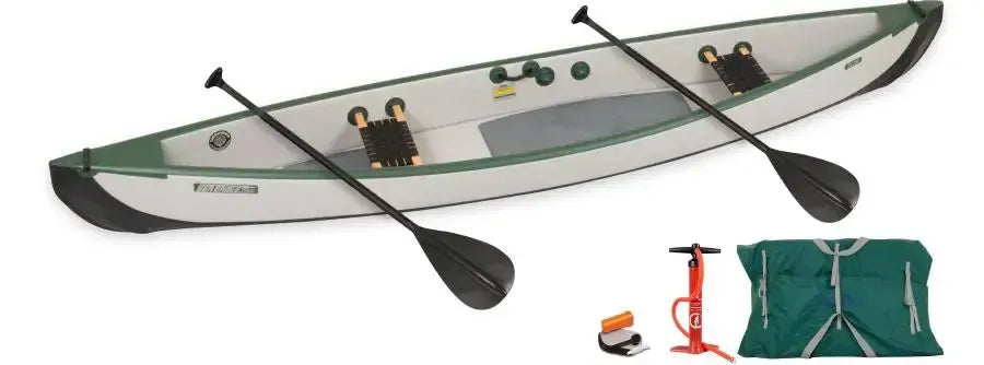 Green and white Sea Eagle TC16 inflatable canoe with two paddles, pump, and storage bag.