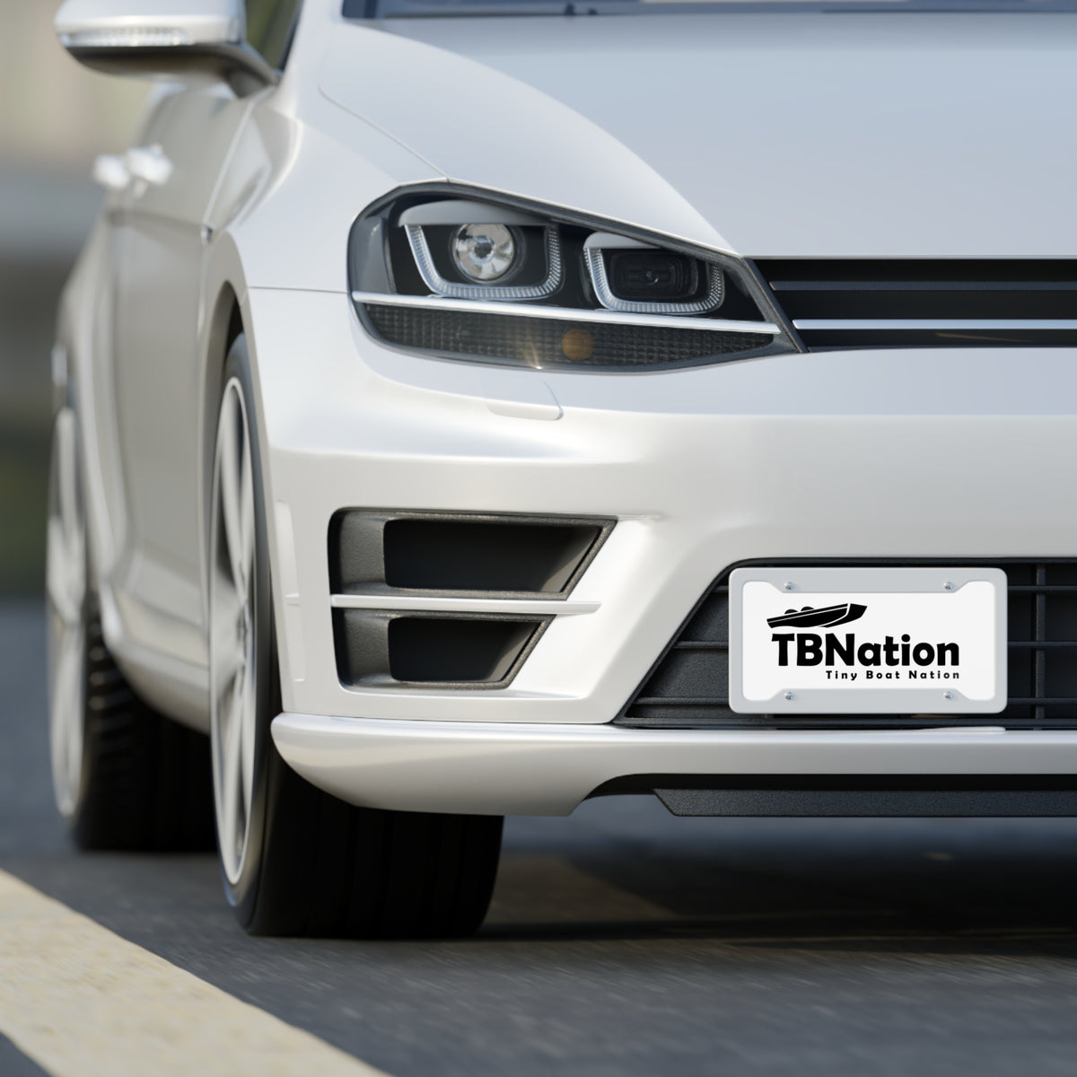 White car with a 'TBNation' license plate on a road