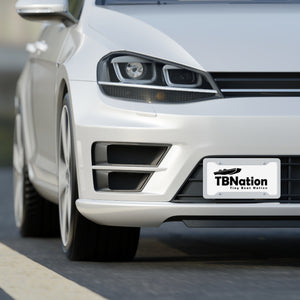 White car with a 'TBNation' license plate on a road