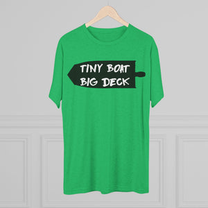 Green t-shirt with 'Tiny Boat Big Deck' text on a hanger against a gray background