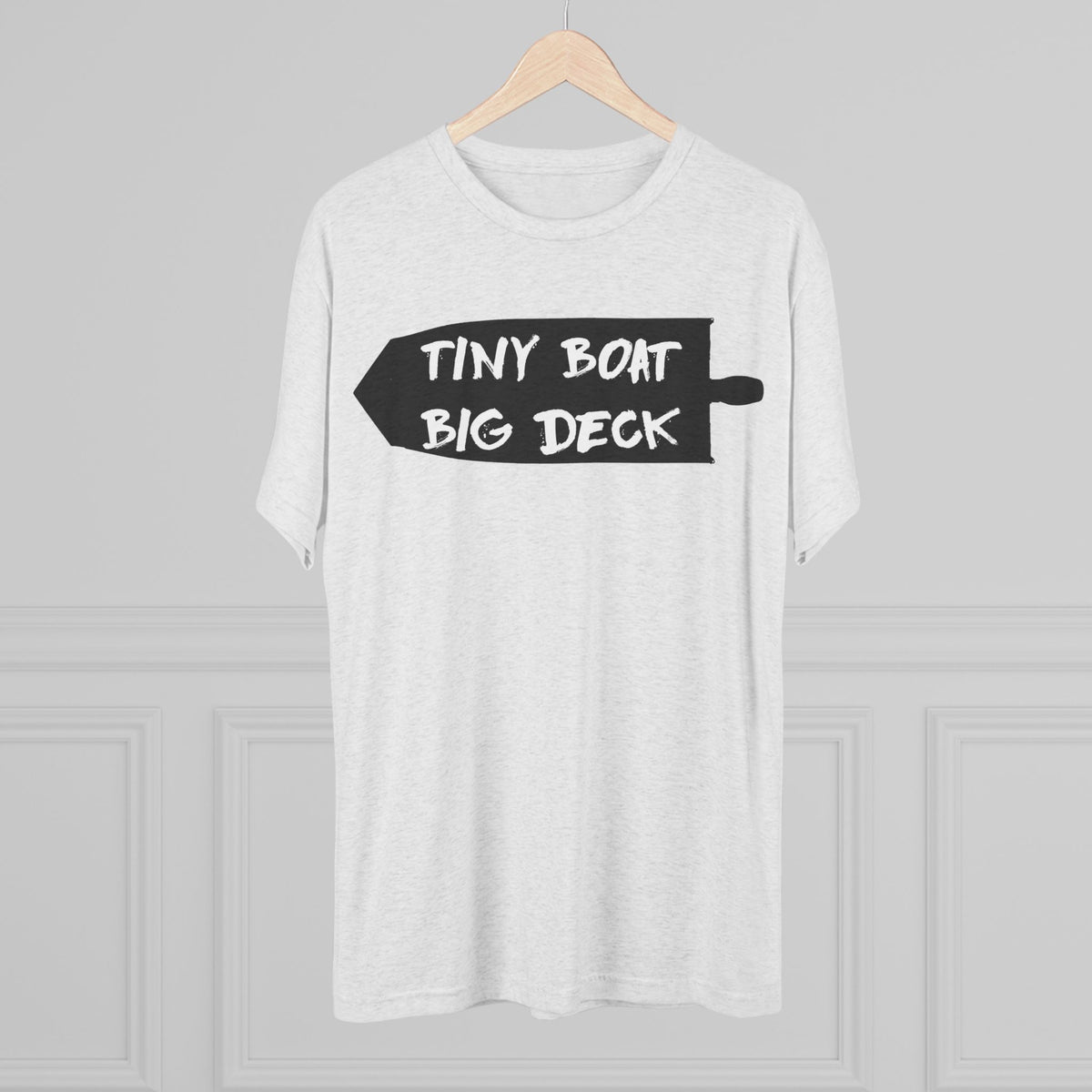 White t-shirt with 'Tiny Boat Big Deck' text on a hanger against a gray background