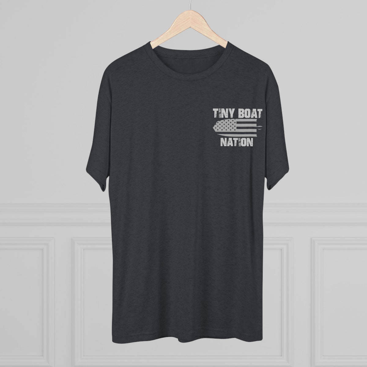 Black t-shirt with 'Tiny Boat Nation' text on a hanger against a gray background