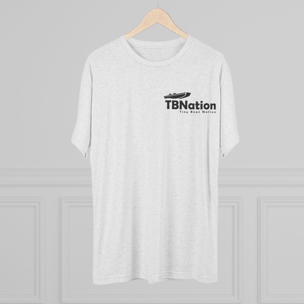 White t-shirt with 'TBNation' logo on a wooden hanger against a gray background