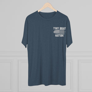 Navy blue t-shirt with 'Tiny Boat Nation' text on a hanger against a gray background