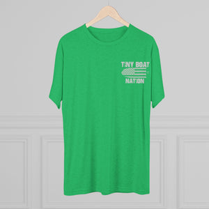 Green t-shirt with 'Tiny Boat Nation' text on a hanger against a gray background