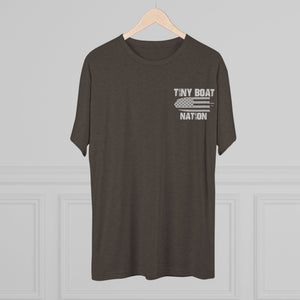 Brown t-shirt with 'Tiny Boat Nation' text on a hanger against a gray background