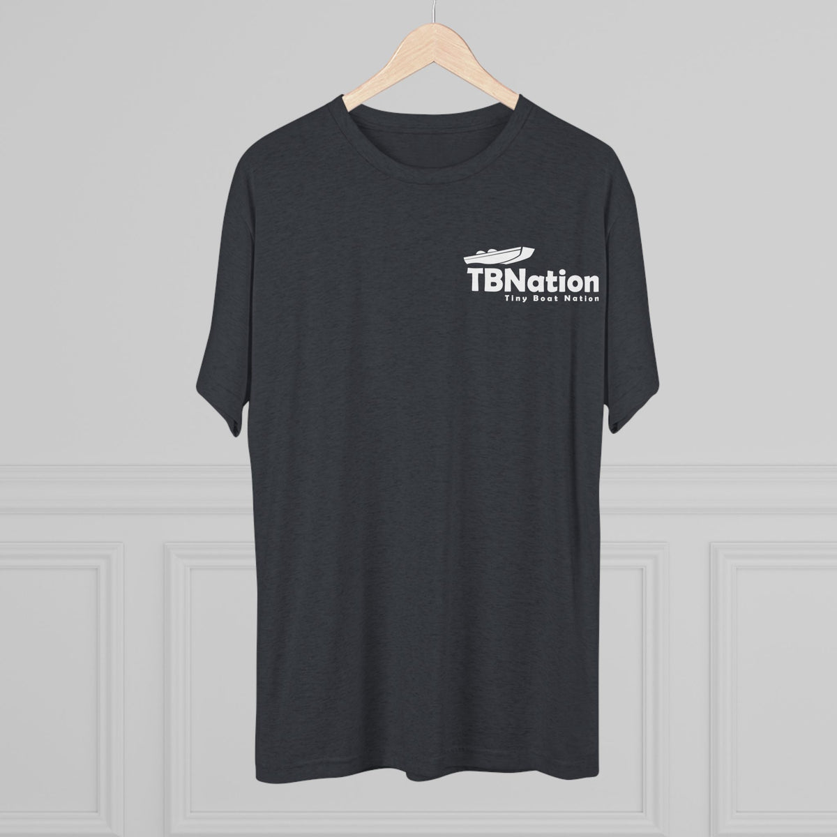 Black t-shirt with 'TBNation' logo on a hanger against a gray background