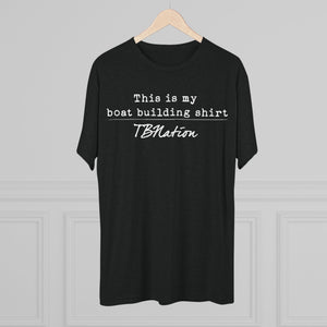Black t-shirt with text on a hanger against a gray background