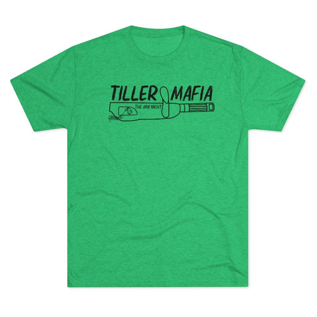 A green heather crewneck t-shirt with a black graphic print on the chest reading 'TILLER MAFIA' above a revolver illustration and the text 'THE JON YATCH'.