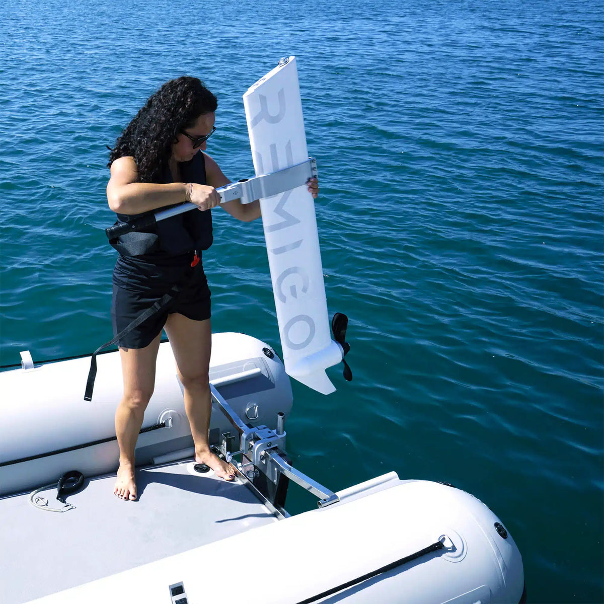 Lightweight 32lb Remigo electric outboard for sale being carried by handle