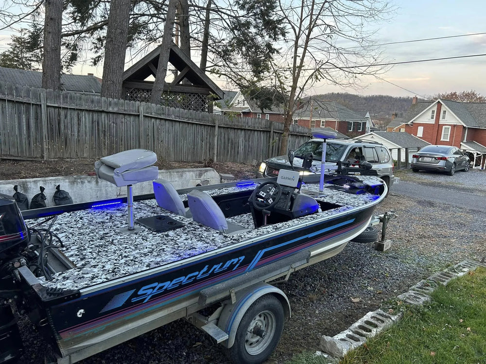 Spectrum boat featuring custom camo EVA foam flooring and blue LED boat lights.