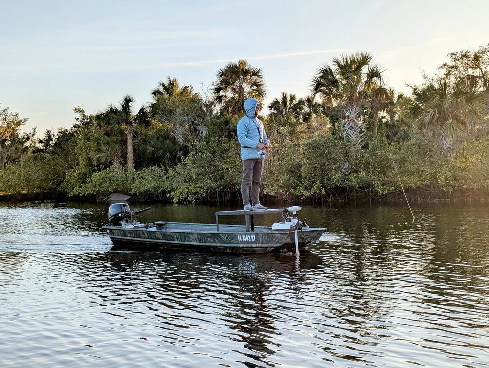 Jon boat helm console featuring black and white camo marine foam decking and blue LED accent lights.