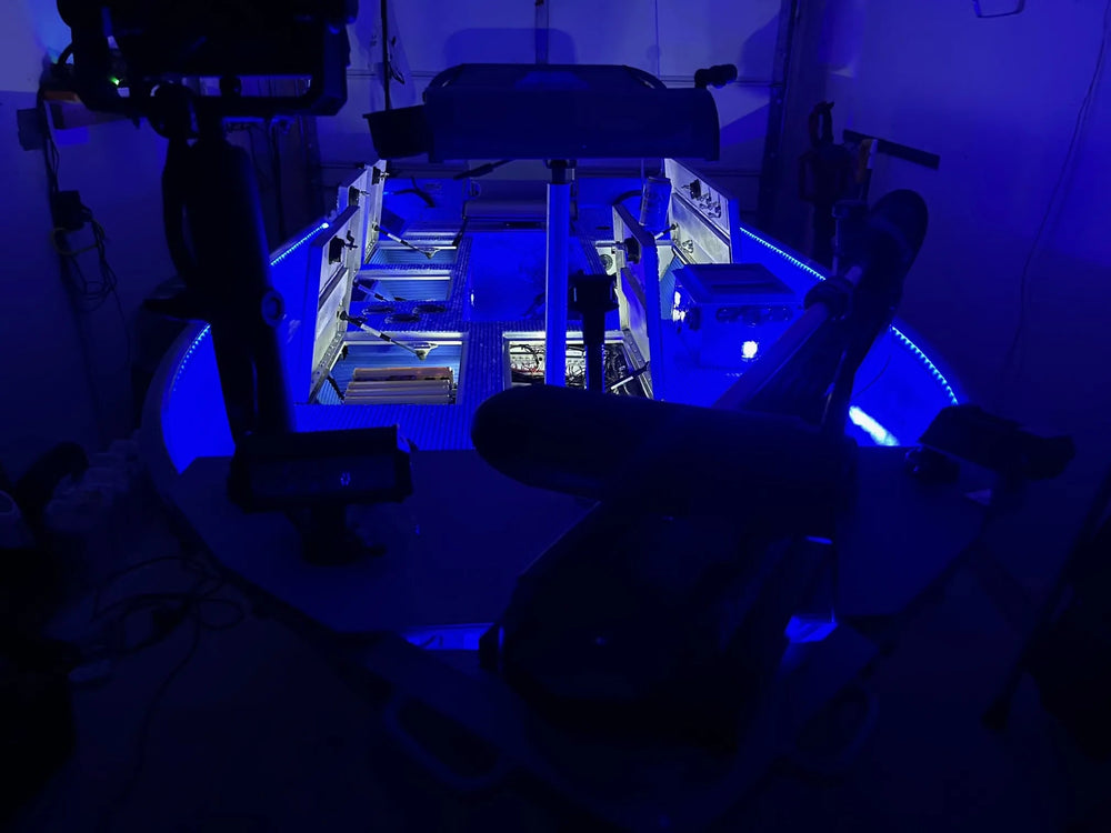 Custom camo Jon boat with a raised casting platform on the water.