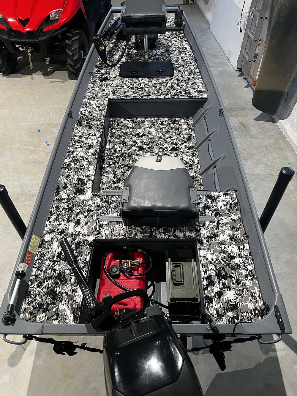 Marine battery compartment with lithium batteries, NOCO charger, and clean boat wiring.