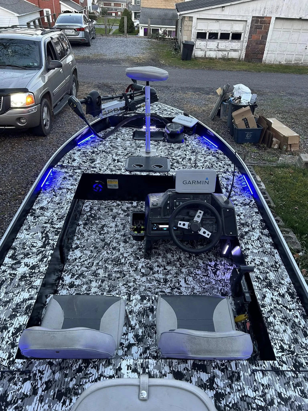 Custom boat interior illuminated by blue LED deck light strips at night.