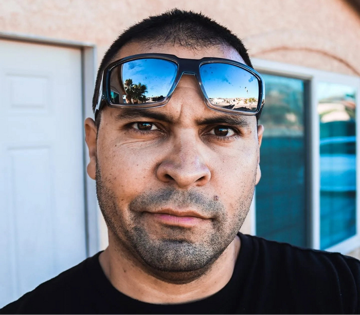 Mike Lopez, TBNation team member, wearing sunglasses and looking confidently at the camera, representing the experienced professionals behind TBNation's marine products and customer service.