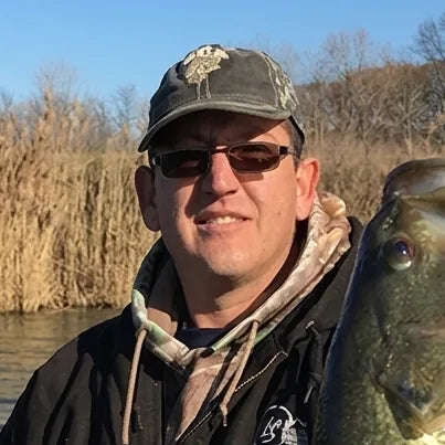 Nate Eckhold, TBNation team member, posing outdoors with a freshly caught fish, reflecting his passion for fishing, boating, and the outdoor lifestyle.