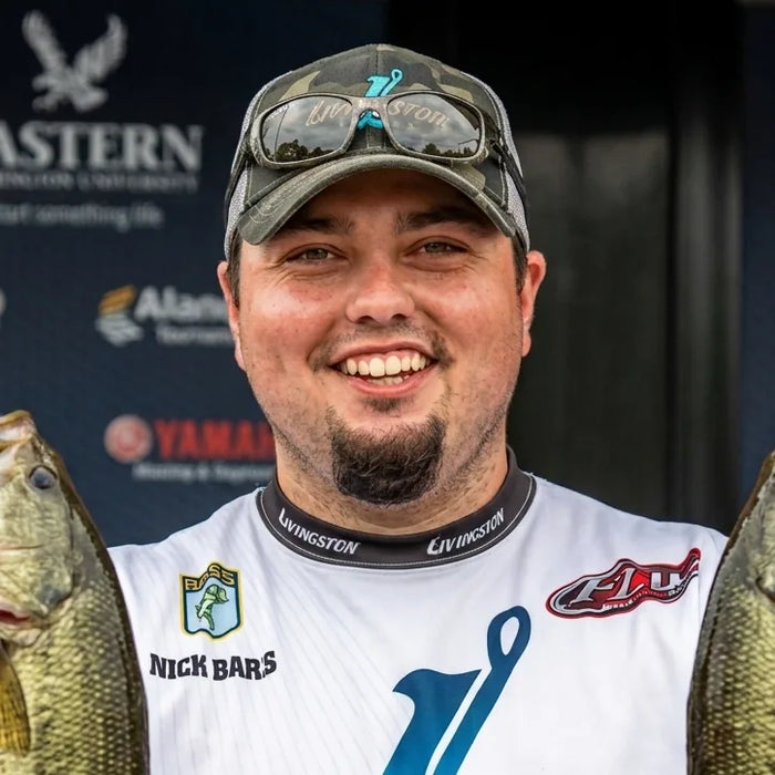 Nick Barr, TBNation team member, smiling while holding freshly caught fish at a fishing tournament, showcasing his passion for competitive angling and the outdoor lifestyle.