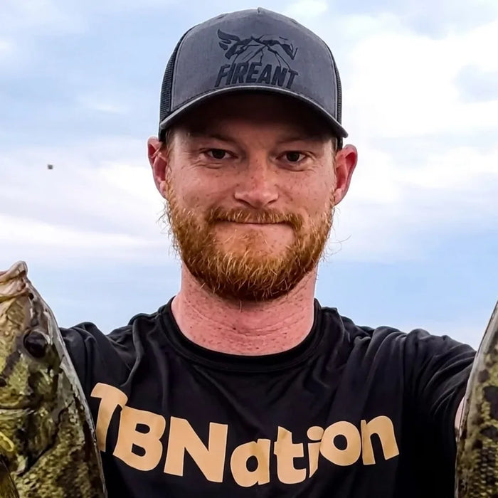Ryan Marquis, TBNation team member, holding freshly caught fish and smiling outdoors, reflecting his passion for fishing, boating, and the outdoor lifestyle.