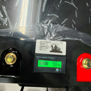 Black Hi-Power 48V lithium battery with a green digital display showing 98% capacity and red/gold terminals.