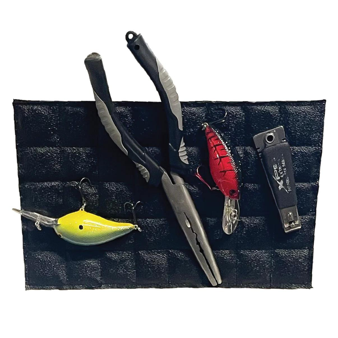 Black Magnalure Pad holding fishing pliers, a yellow lure, a red lure, and snips.