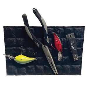 Black Magnalure Pad holding fishing pliers, a yellow lure, a red lure, and snips.