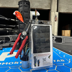 Black Magnalure magnetic wrap on a boat pedestal, holding lures, hooks, and red pliers.