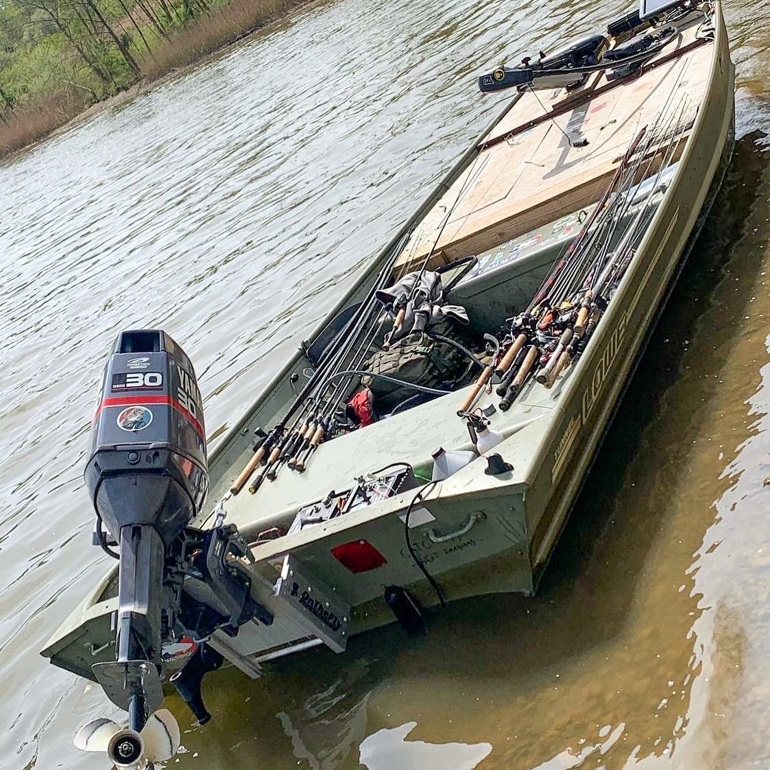 Green aluminum fishing boat with a black 30hp motor and an OnTheFly Jackplate.