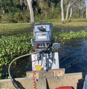 Silver OnTheFly Electric Jackplate mounted on a boat transom with a gray Yamaha outboard motor.