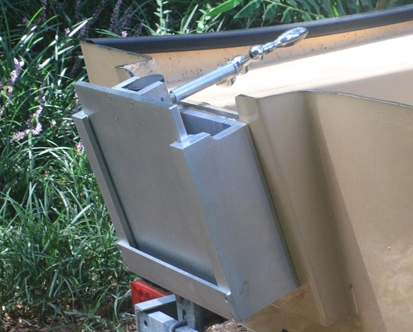 Silver aluminum OnTheFly Manual Jackplate installed on a boat transom with a chrome handle.