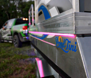 Pink Plashlight RGBW flexible light strip illuminating the side of a "Pond-Tini" pontoon boat.