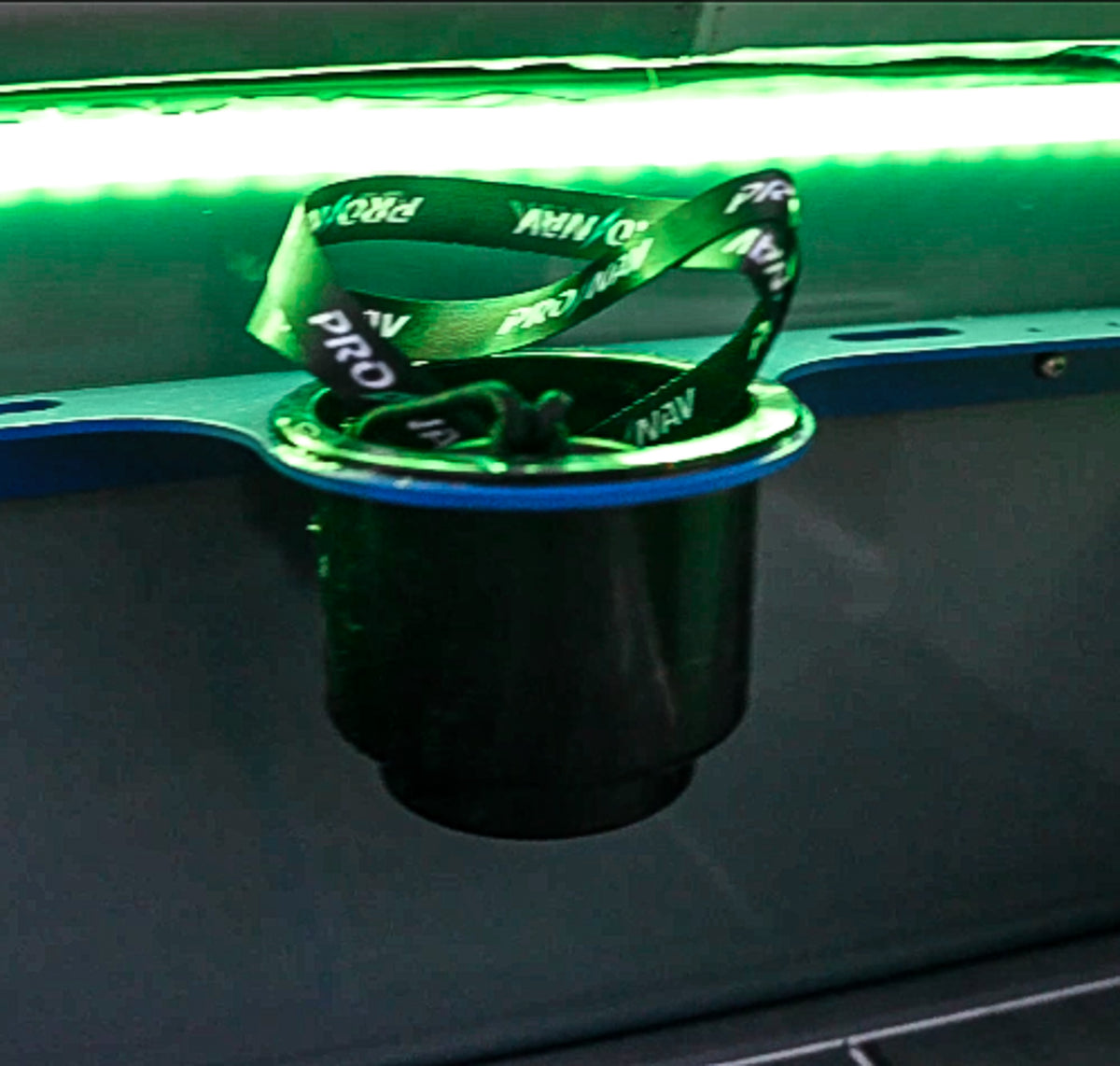 Green Plashlight 12V RGBW flexible light strip illuminating a black cup holder with a blue rim.