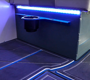 Blue Plashlight 12V RGBW flexible light strip illuminating a boat interior with a cup holder.