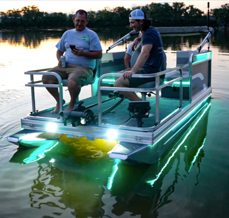 Two men on a boat with bright Plashlights EPIK underwater transom lights glowing green and white.