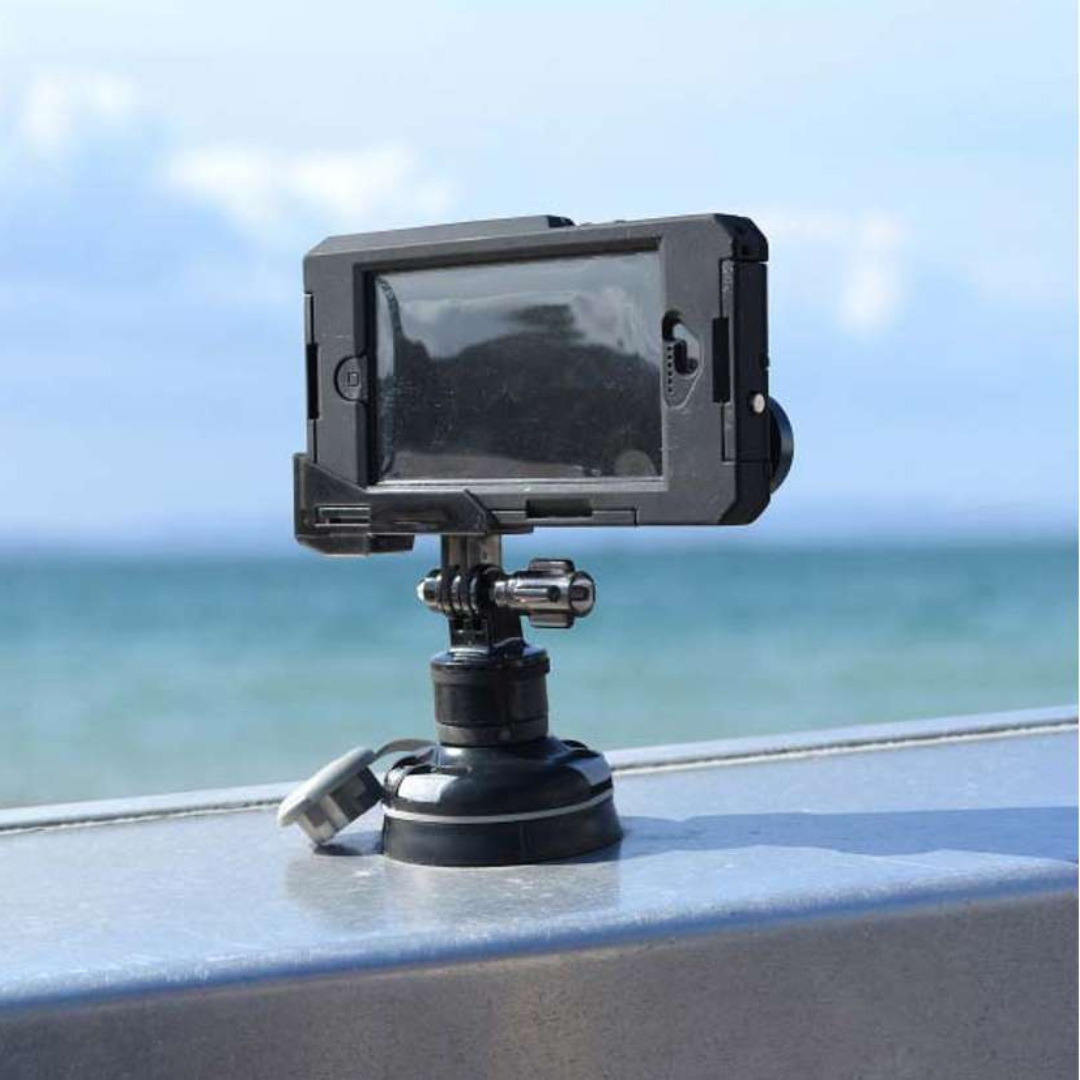 Black Railblaza Camera Mount Adapter with a smartphone in a waterproof case, attached to a surface by the ocean.