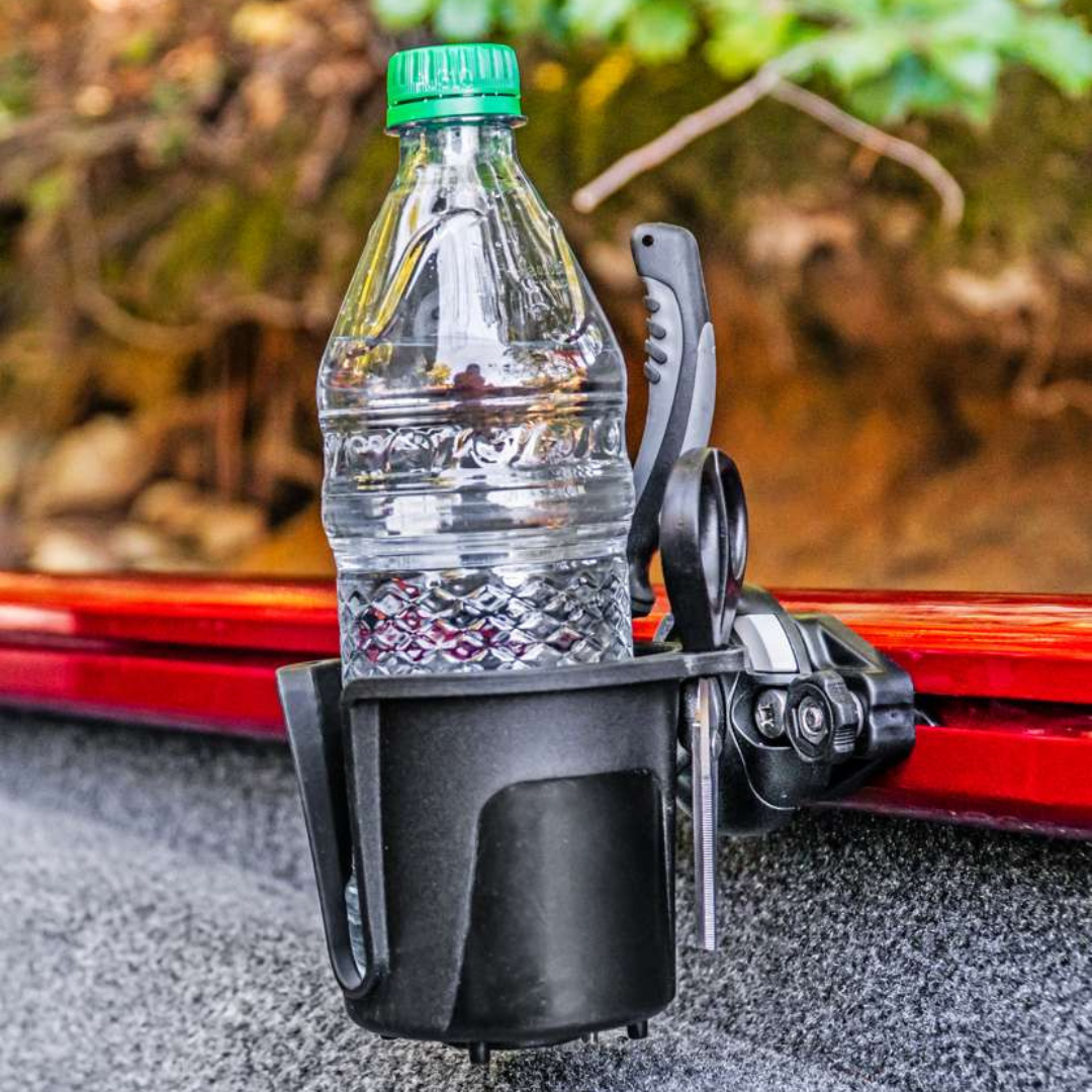 Black Railblaza DrinkHold with a water bottle and pliers, mounted on a red boat rail.