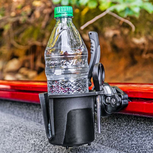Black Railblaza DrinkHold with a water bottle and pliers, mounted on a red boat rail.