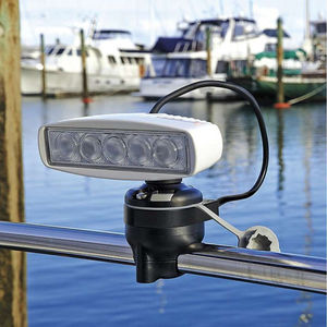 White Railblaza E Series Cable Entry Port Base with a mounted light, attached to a silver boat rail.