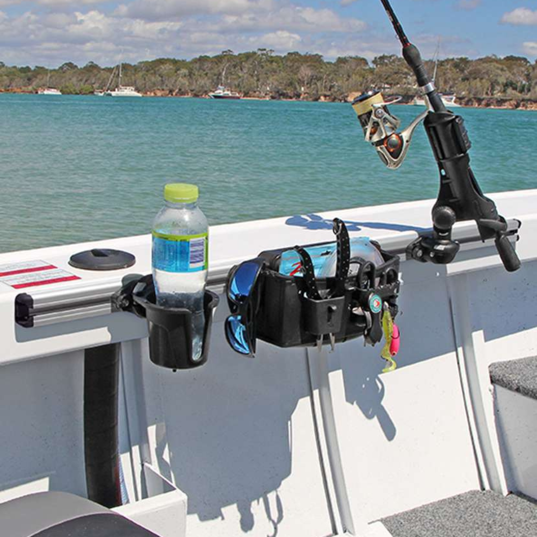 Silver anodized aluminum Railblaza TracLoader Gunnel Track with black cup holder and tackle storage on a boat.