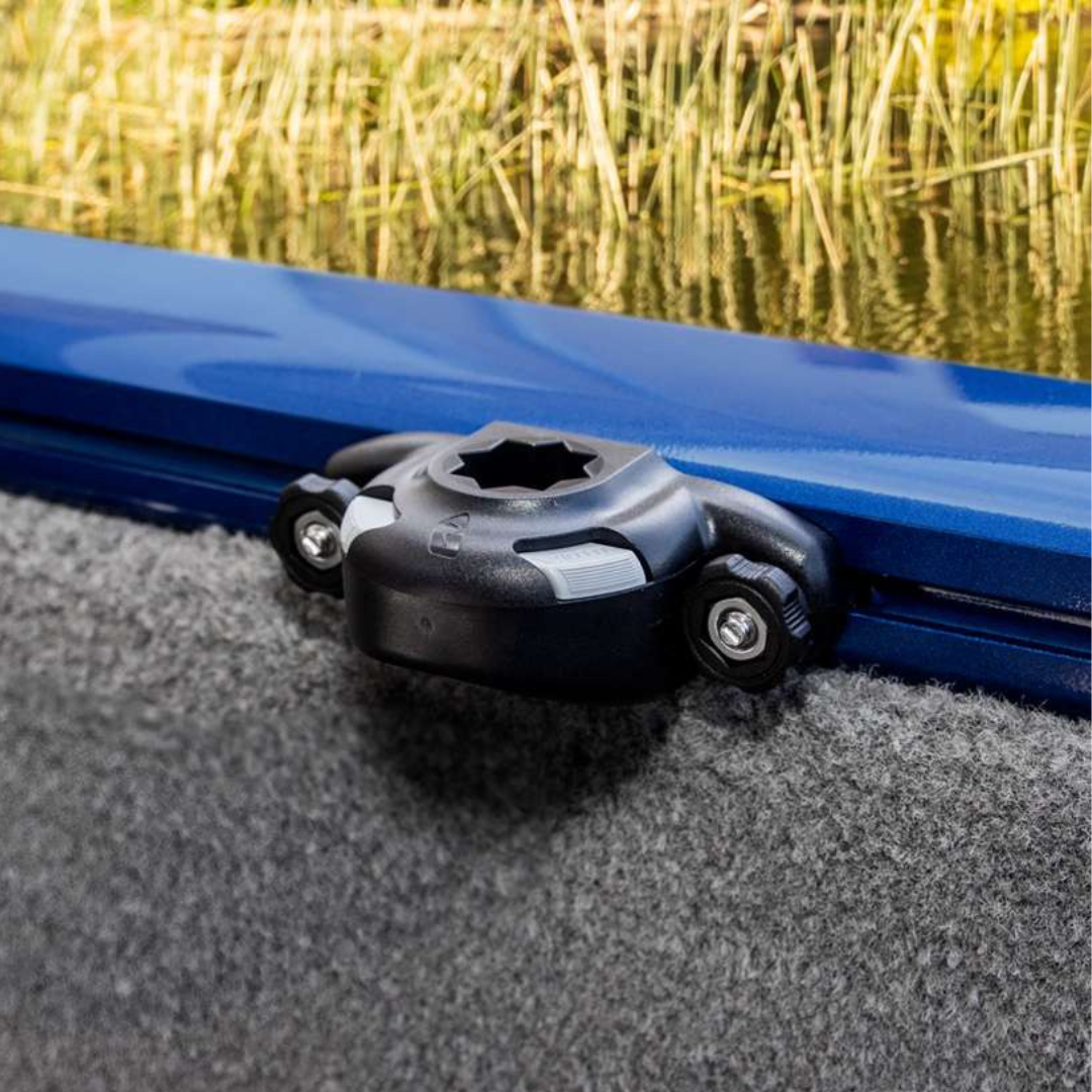 Black Railblaza Trackloader Sideport boat accessory mounted on a blue gunnel track, with a grey carpeted boat interior.
