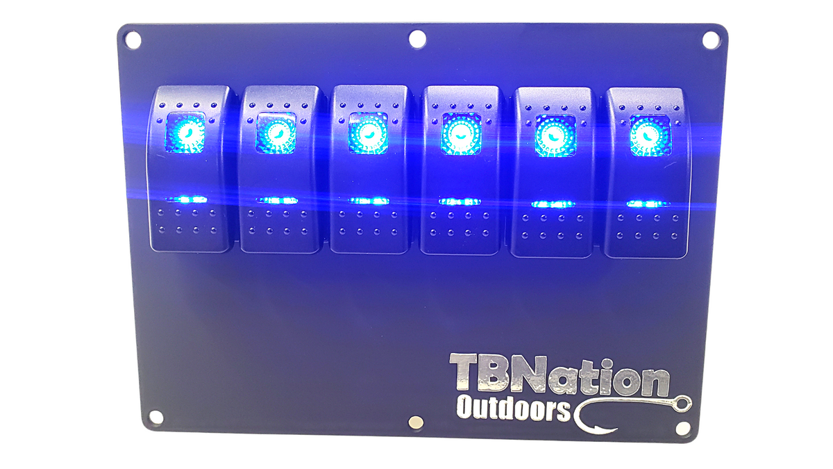 Black 6-gang TBNation Outdoors hydro-dipped aluminum switch panel with six glowing blue rocker switches.