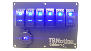 Black hydro-dipped aluminum TBNation 6-gang rocker switch panel with bright blue LED switches and voltmeter.
