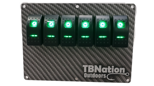 TBNation 6-gang carbon fiber hydro-dipped aluminum switch panel with six illuminated green rocker switches.